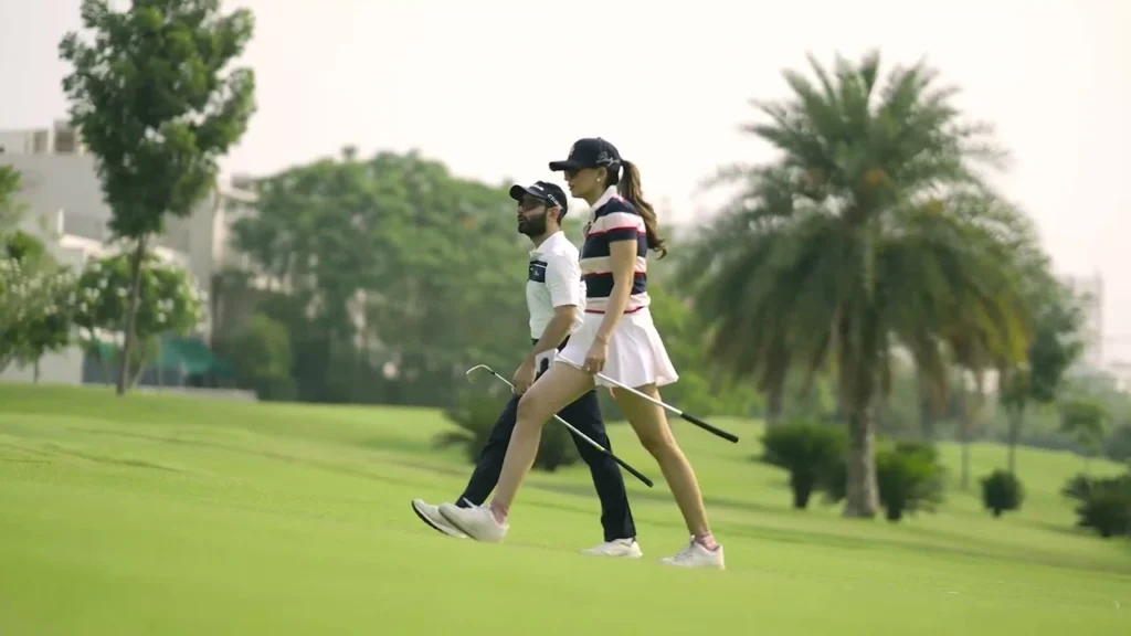 Godrej Crown Residences Sector 27 Greater Noida - couple walking along the golf greens